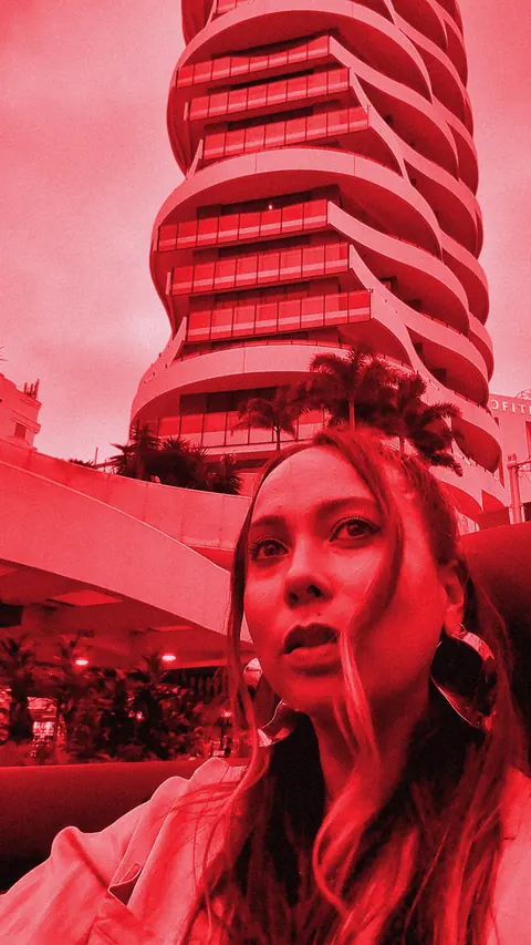 ROMII in front of a sculpted high-rise on the Gold Coast, red-toned still
